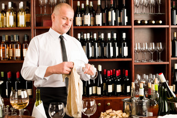 Wine bar waiter clean glass in restaurant