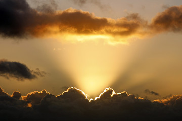 Sun rays and dark clouds