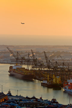 Plane and Cranes at the Port of Barcelona at Sunset