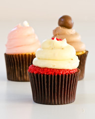 Mini cupcakes with cream strawberry and chocolate frosting