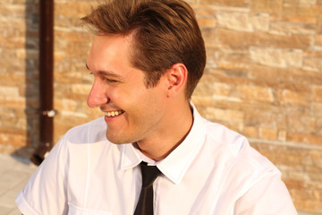 Satisfied smiling businessman, near house, outdoors