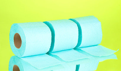 blue rolls of toilet paper on green background