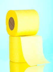 two yellow rolls of toilet paper on blue background