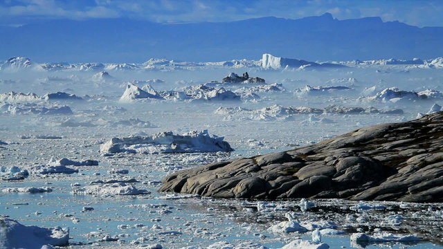 Melting Ice Floes Moving Between Icebergs