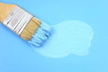 Paintbrush swirling a new coat of blue paint