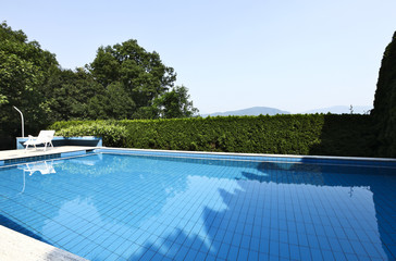Chaise longue and swimming pool