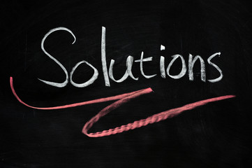 Obraz premium Solutions written on blackboard