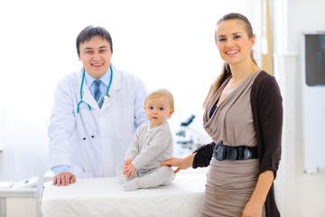 Mother and baby on examination at pediatric cabinet