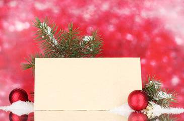 blank postcard, Christmas balls and fir-tree on red background
