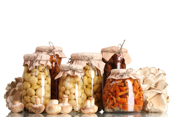 delicious marinated mushrooms in the glass jars and raw