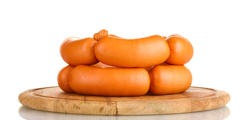 tasty sausages on wooden board isolation on white