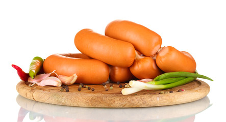 tasty sausages on wooden board and spices isolation on white