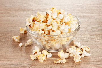 popcorn in glass bowl on wooden table