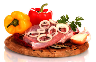 Raw meat and vegetables on a wooden board isolated on whitе