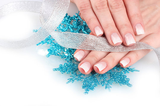 hands with beautiful winter design, snowflakes and ribbon