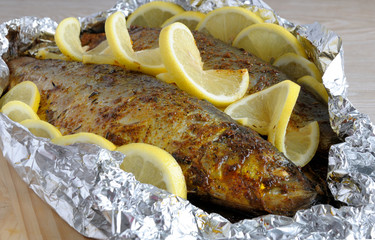 Baked herring in spices and herbs in foil