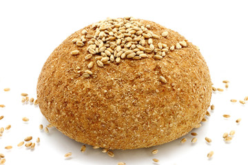 Bread and wheat seeds on a white background