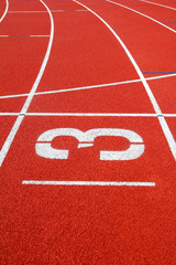 Number 3 on the start of a running track