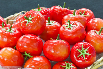 pile of fake tomato in bamboo basket