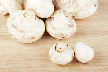 Fresh mushrooms on the wooden breadboard