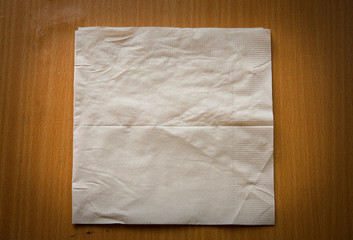 beige cocktail napkin on wooden