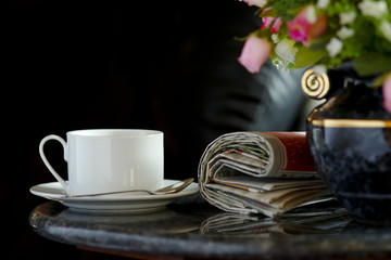 Coffee cup with flower and newspaper