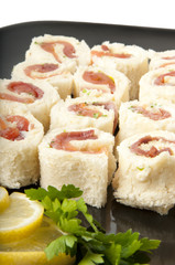 Smoked salmon rolls on white background