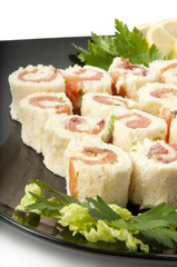 Smoked salmon rolls on white background
