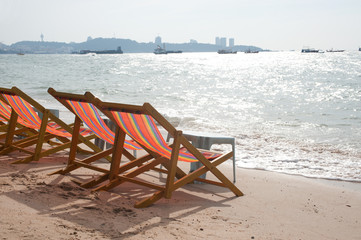 Deck chairs on Pattaya beach in Thailand.