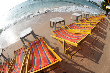 Fototapeta na wymiar Deck chairs on Pattaya beach in Thailand.