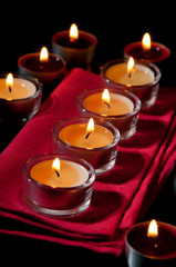 Row of burning tea light candles
