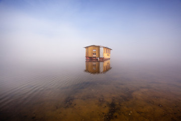 Fototapeta na wymiar yellow cottage and lake