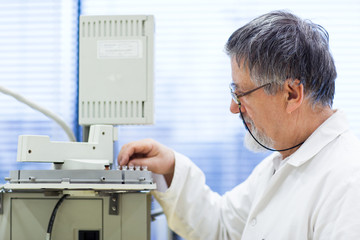 Fototapeta na wymiar senior male researcher carrying out scientific research in a lab