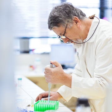 senior male researcher carrying out scientific research in a lab