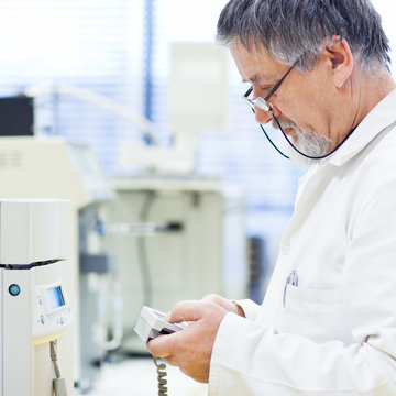 senior male researcher carrying out scientific research in a lab