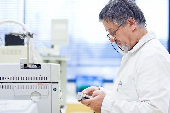senior male researcher carrying out scientific research in a lab
