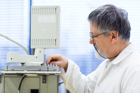 senior male researcher carrying out scientific research in a lab