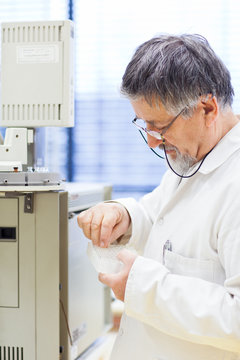 senior male researcher carrying out scientific research in a lab