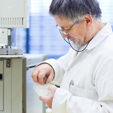 senior male researcher carrying out scientific research in a lab