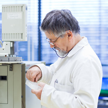 senior male researcher carrying out scientific research in a lab