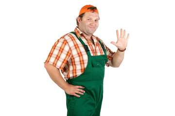 Cheerful worker in overalls and a baseball cap