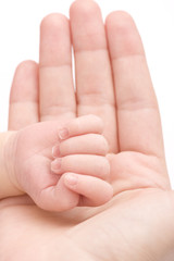 Close-up of baby's hand holding mother's finger