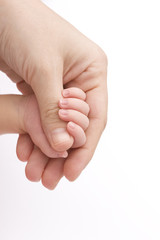 Close-up of baby's hand holding mother's finger