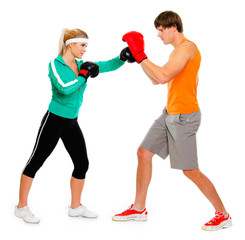 Young woman and man in boxing gloves practicing