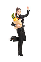 Young female holding a paper bag with groceries