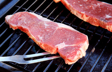 Strip Loin Steaks On The BBQ - ready for grilling