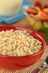 Puffed rice cereal with fruits and milk in the back