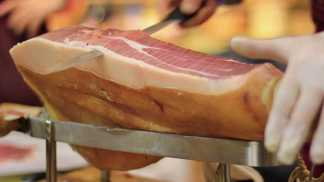 Expert caterer slicing ham