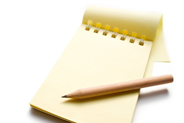 Notepad and pencil on the white background