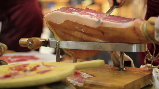 Expert caterer slicing ham